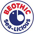 The image shows the logo of "Beothic Sea-licious." The circular logo has a blue stylized fish in the center, with the word "BEOTHIC" in red capital letters at the top and "Sea-Licious" in blue capital letters at the bottom. The background is white.