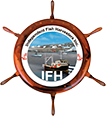 A logo featuring a ship’s wheel with a central image of a small fishing boat navigating near a harbor with other boats. The text "International Fish Harvester Co." is written around the central image. The letters "IFH" are displayed prominently at the bottom.