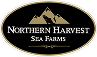 Logo of Northern Harvest Sea Farms. The design features a black oval with a beige mountain range and fish graphic at the top. The text "Northern Harvest Sea Farms" is centered in white capital letters, separated by a small horizontal line.